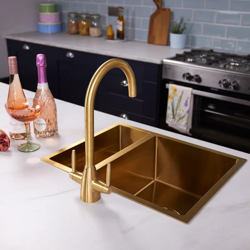 Ellsi Astrid brushed brass kitchen tap showing the swan neck spout from an angle