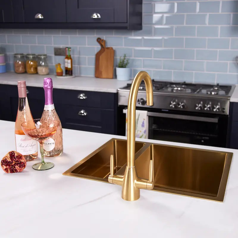 Ellsi Astrid brushed brass kitchen tap over a double bowl gold kitchen sink