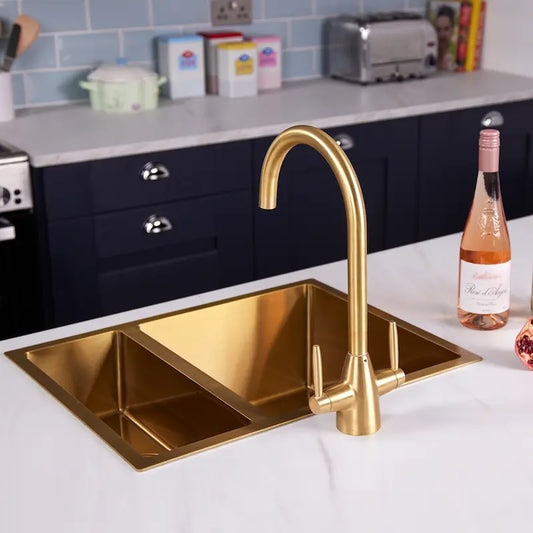 Astrid dual lever gold kitchen tap in a navy kitchen with blue metro tile splashback