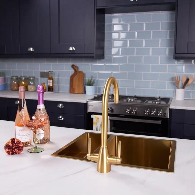 Ellsi Astrid gold dual lever kitchen mixer tap shown in a full kitchen setting