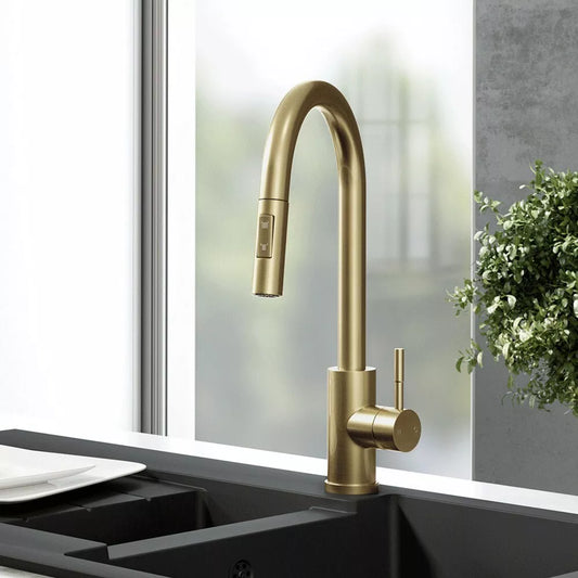Brushed brass kitchen mixer tap on a black sink by Ellsi