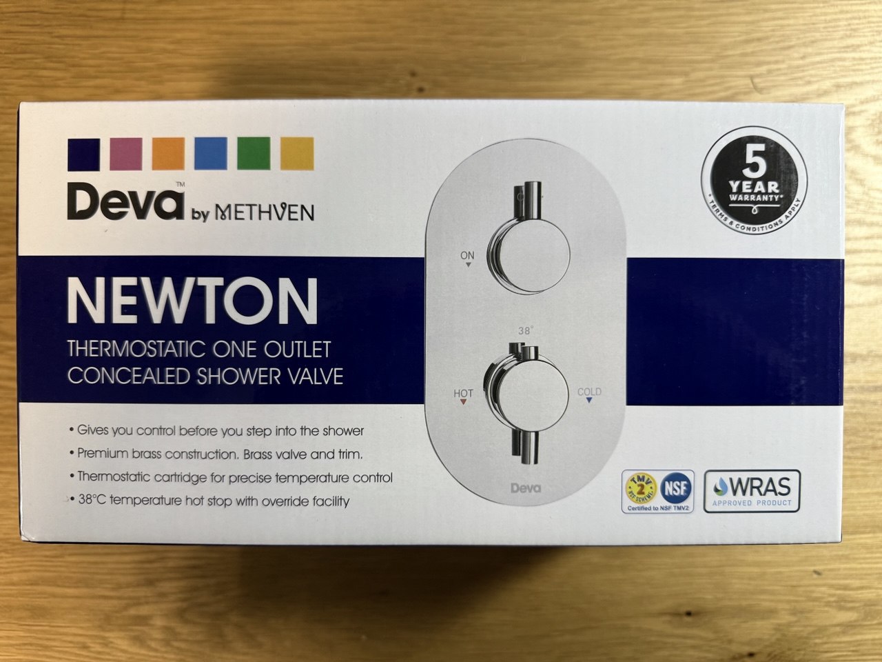 Deva Concealed Newton shower one outlet thermostatic valve packaged in a box on a wooden surface at IrishBath.ie