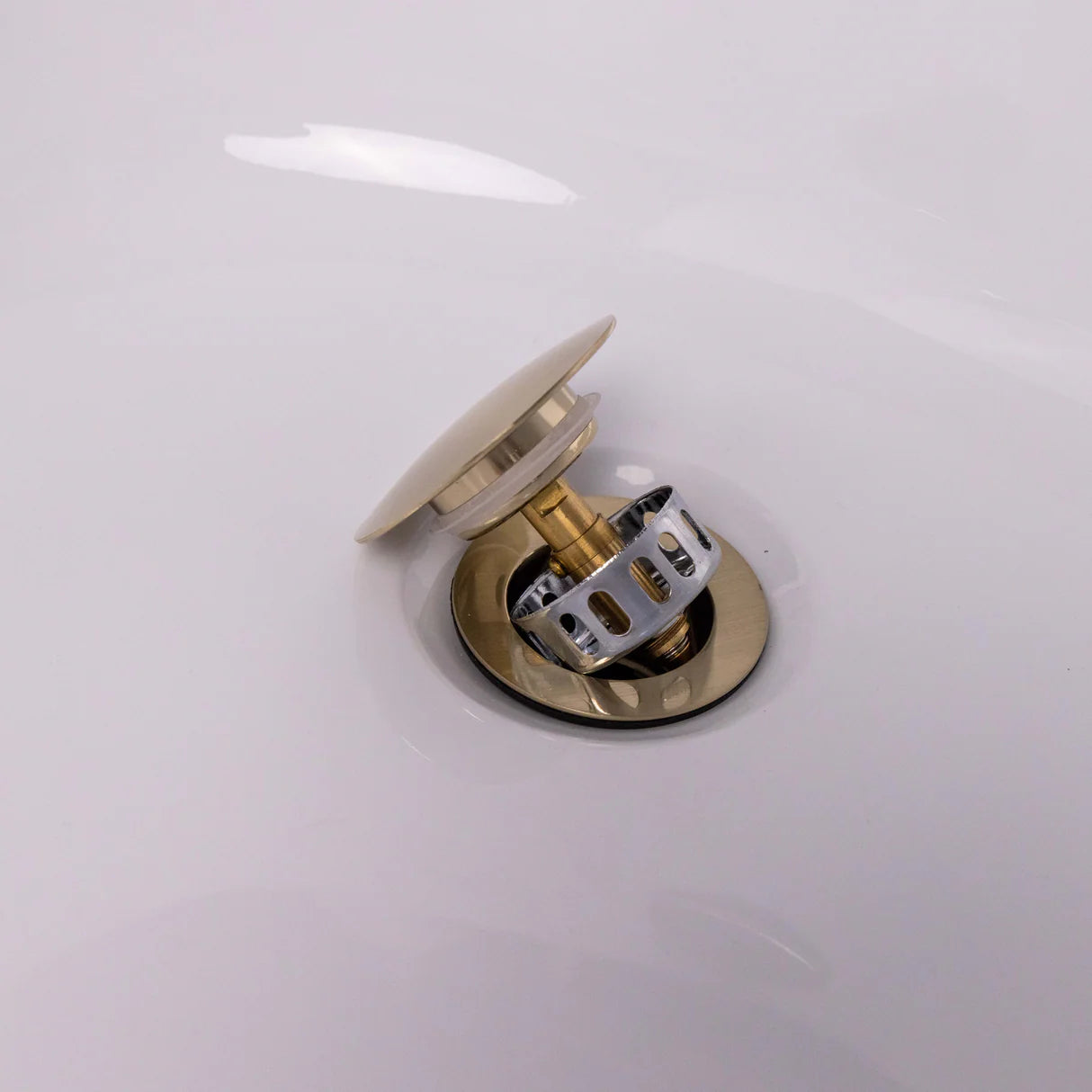 Removable dome and strainer basket in brushed brass finish at bath of IrishBath