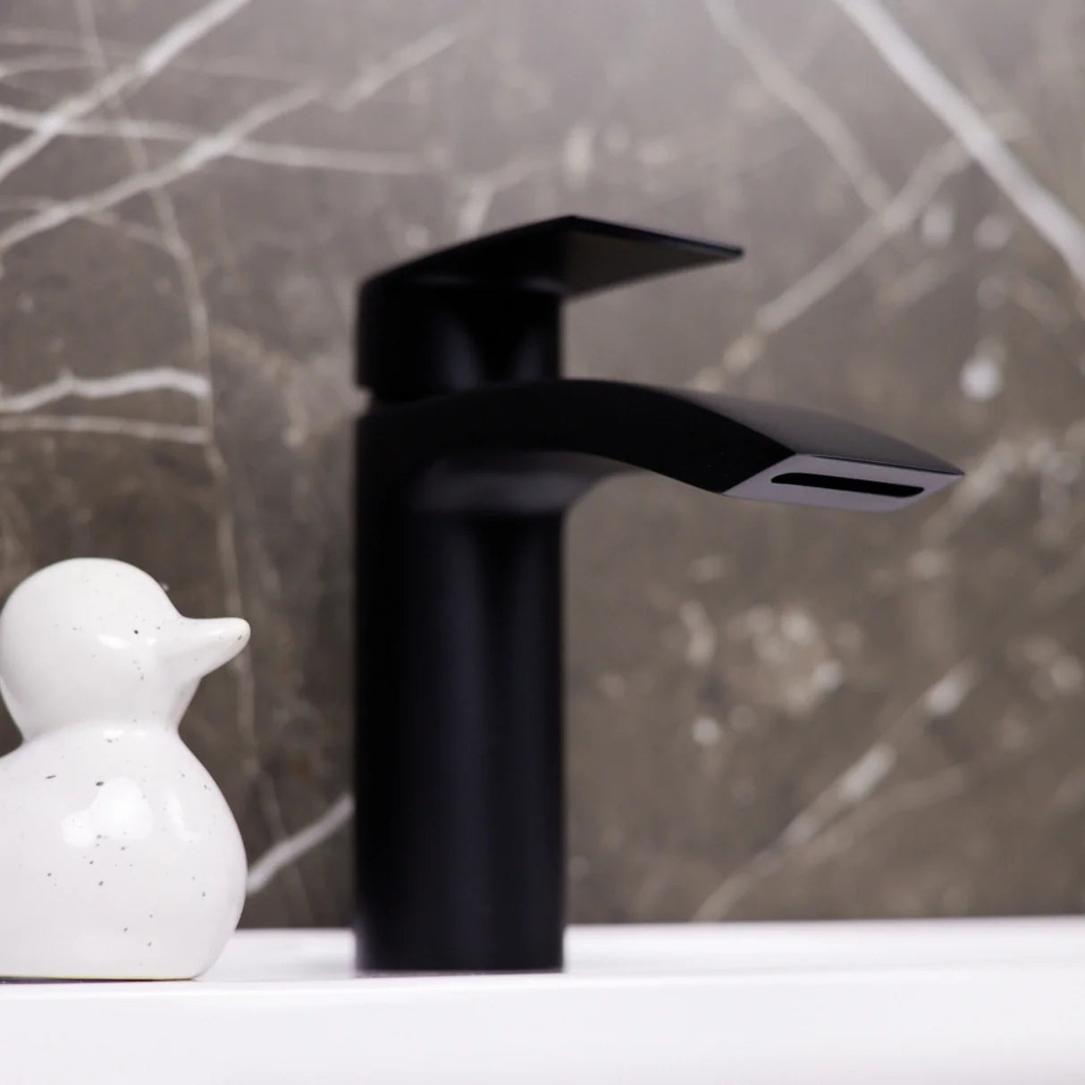 Water cascading from matt black Ellsi Spear waterfall basin mixer tap