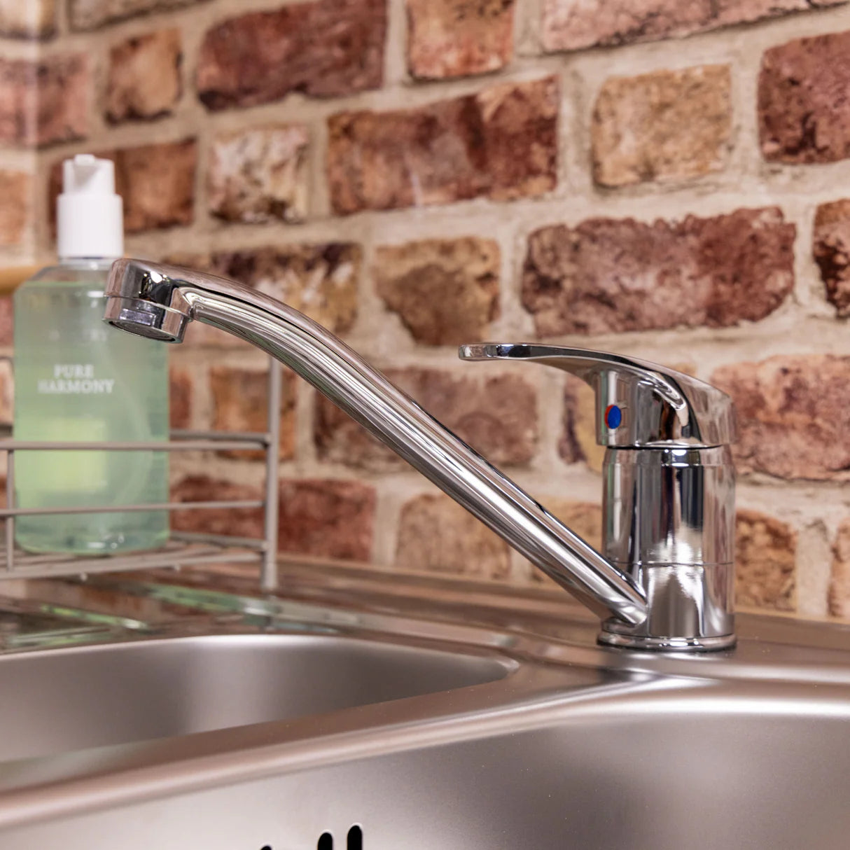 Chrome Vesper single lever kitchen mixer tap on sink