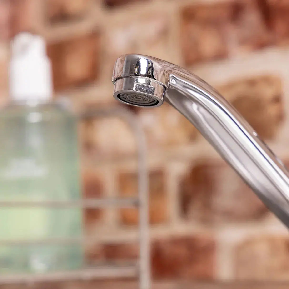 Close-up of a polished Vesper chrome kitchen tap with swivel spout 