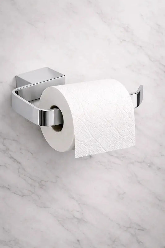 Kartell Chrome toilet paper holder with a roll of toilet paper on a marble wall (ACC302) at IrishBath