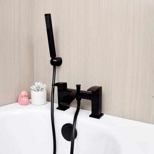Kinlin black bath shower mixer tap on a white surface against a beige wall.