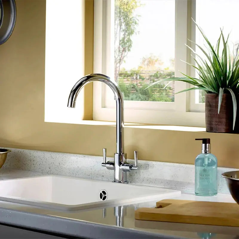 Deva Newton chrome kitchen mixer tap installed on white steel sink at IrishBath