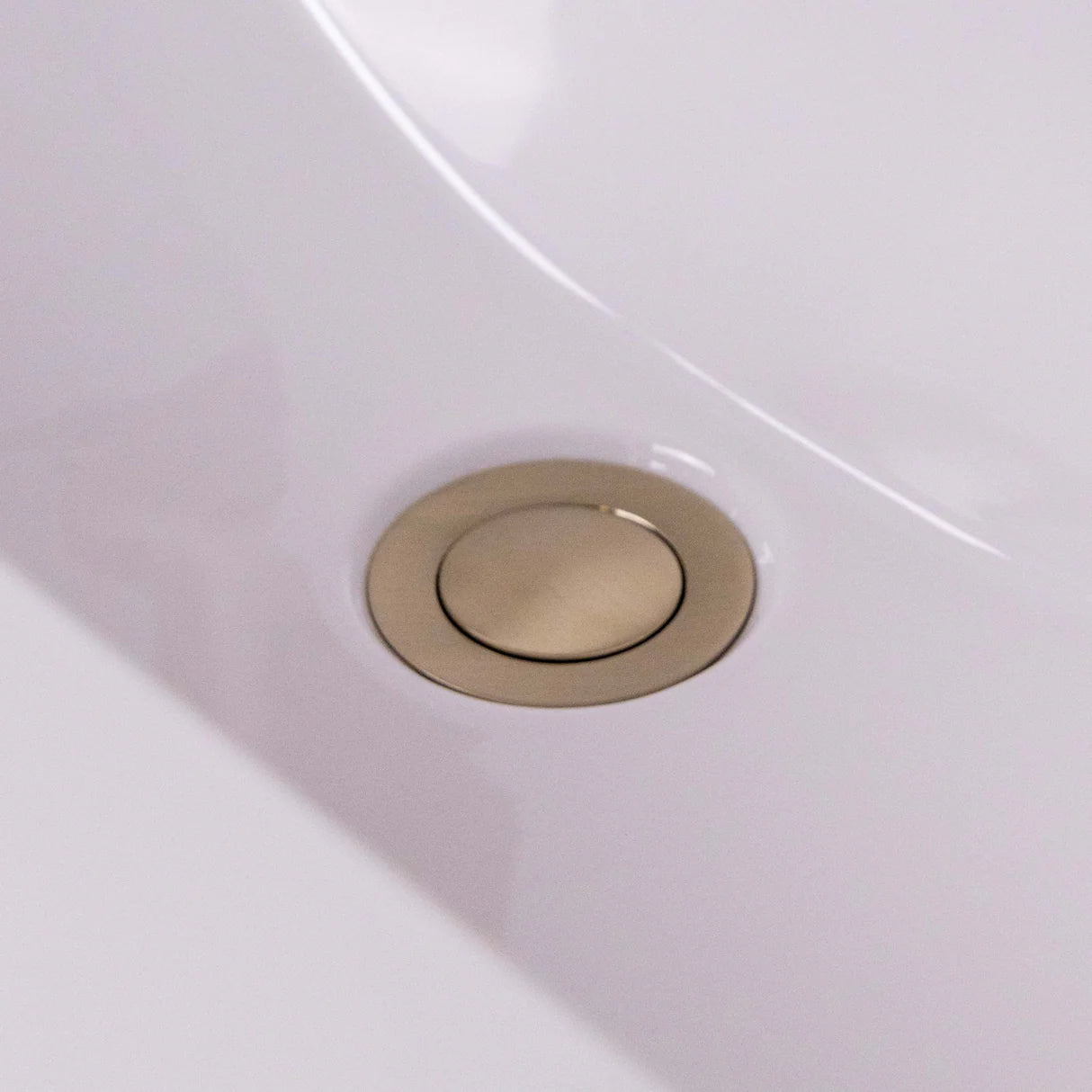 Push-button brushed brass basin waste with overflow slot by Ellsi at IrishBath.ie