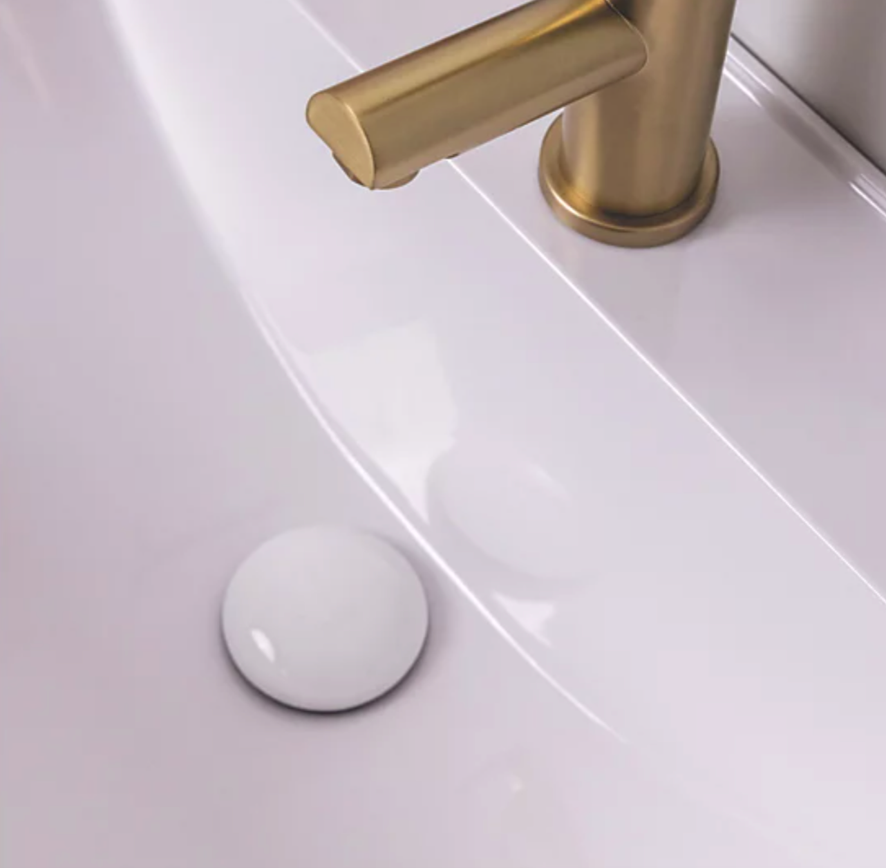 White ceramic unslotted basin waste fitted in modern countertop sink