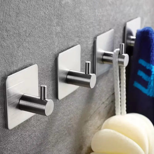 Adhesive stainless steel wall hook holding towel in bathroom – rustproof design