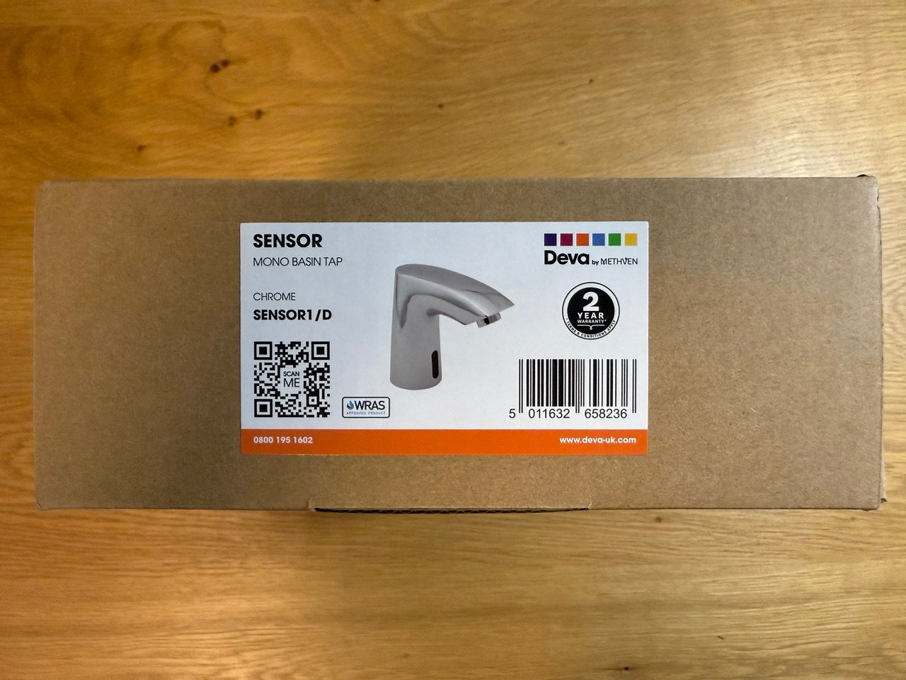 Box with a Deva sensor bathroom faucet label on a wooden surface at IrishBath.ie
