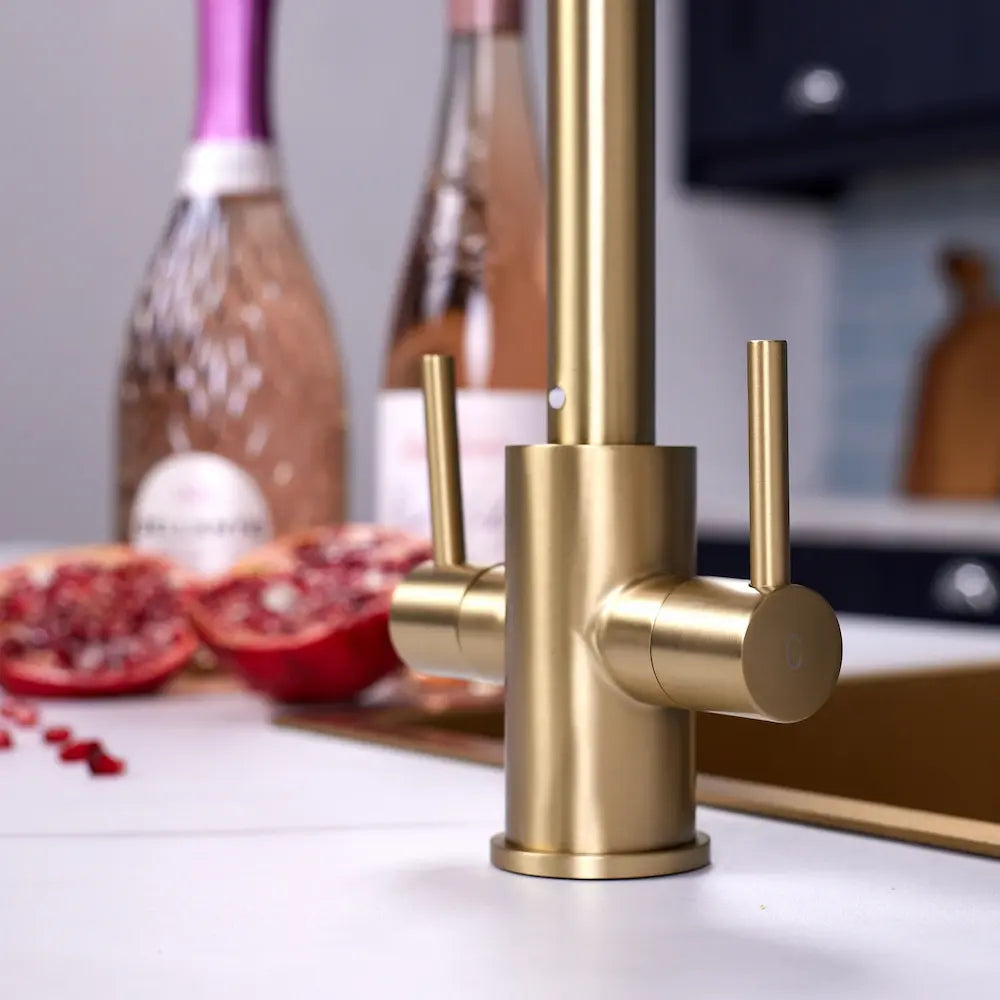 Brushed brass finish on the levers and spout base of the Adria kitchen tap