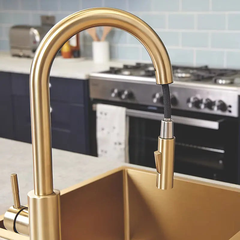 Brushed brass pull-out kitchen tap by Ellsi (Etal) with spray hose extended for sink cleaning at Irishath