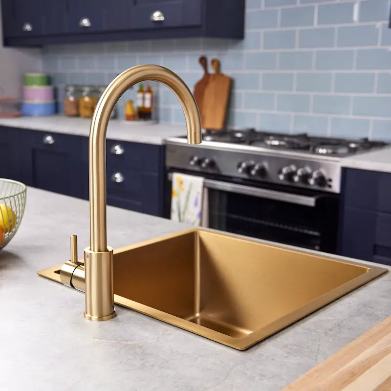 Brushed brass Tivoli kitchen tap swivel spout shown from the side
