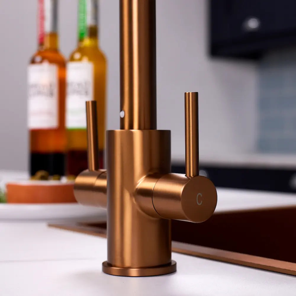 Close-up of the cold lever and brushed copper body of the Adria dual lever tap