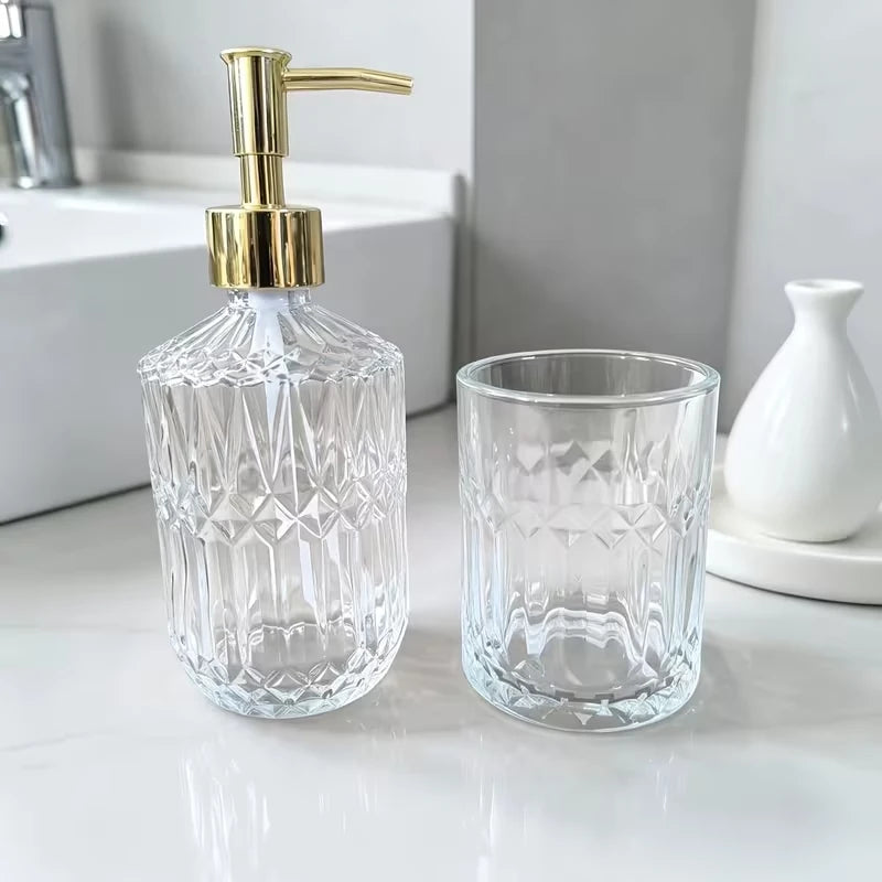 Gold plated pump on the 400 ml cut glass soap dispenser beside the 300 ml toothbrush holder on a white counter