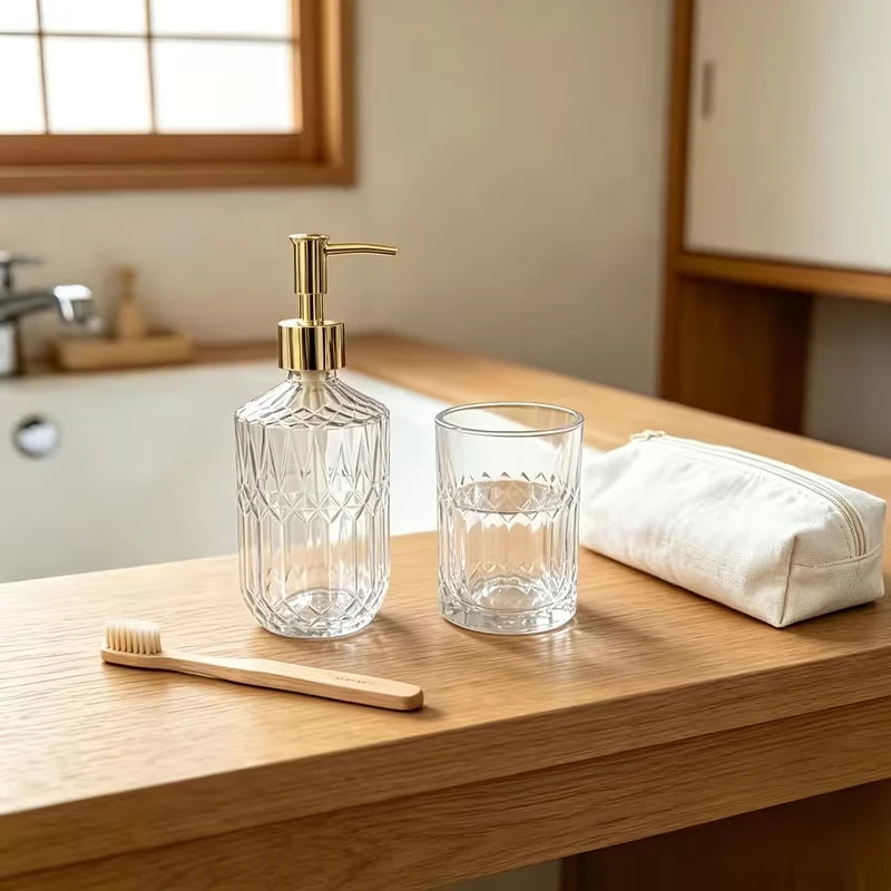 Glass soap dispenser and toothbrush holder set on a wooden vanity top with bamboo toothbrushes