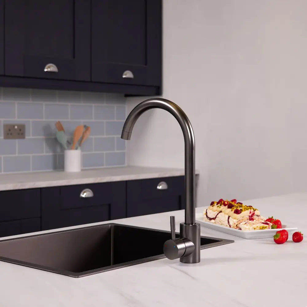 Dark metallic grey Tivoli kitchen sink tap beside a black sink in a navy kitchen