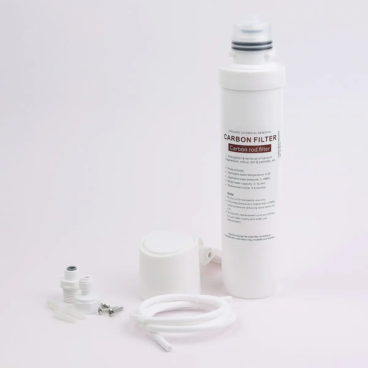 The complete inline water filter kit laid out on a white background: carbon rod cartridge, housing head with wall bracket, quarter-inch push-fit connectors, fixings and a length of tubing