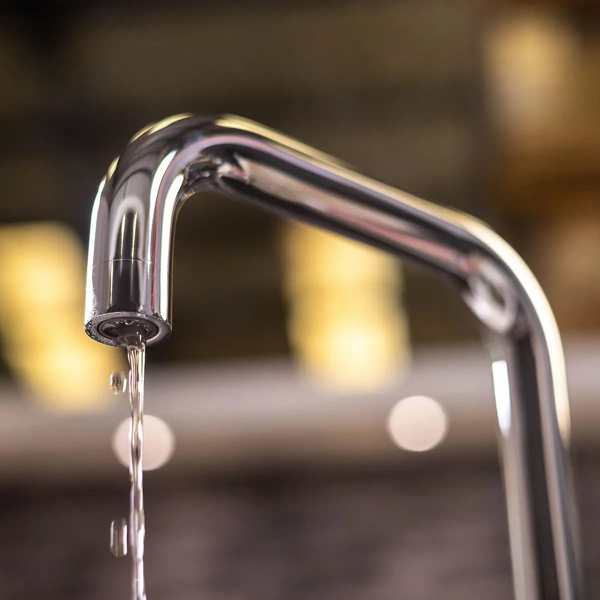 Water running from the squared chrome spout of the instant boiling water tap