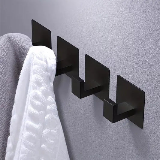 Matt black adhesive wall hook installed on painted wall holding towels by IrishBath.ie
