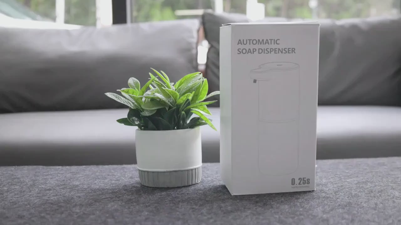 Unboxing and demonstration: the top pad sets the dose, then soap dispenses onto an open hand held under the spout without touching