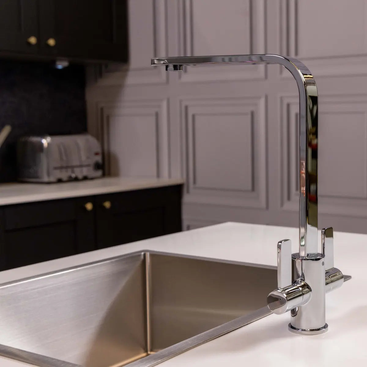 Angled view of the Stroud chrome twin lever tap showing its squared swivel spout